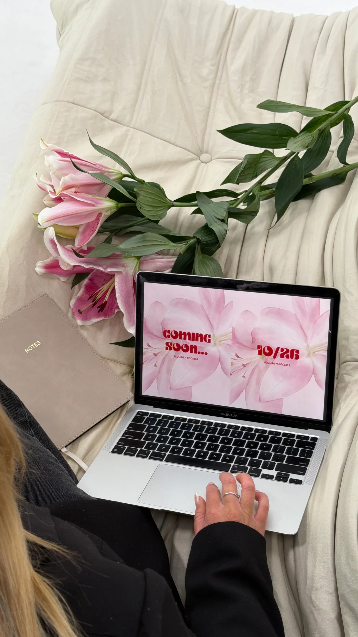 Pink lilies beside a laptop displaying Flourish Socials branding